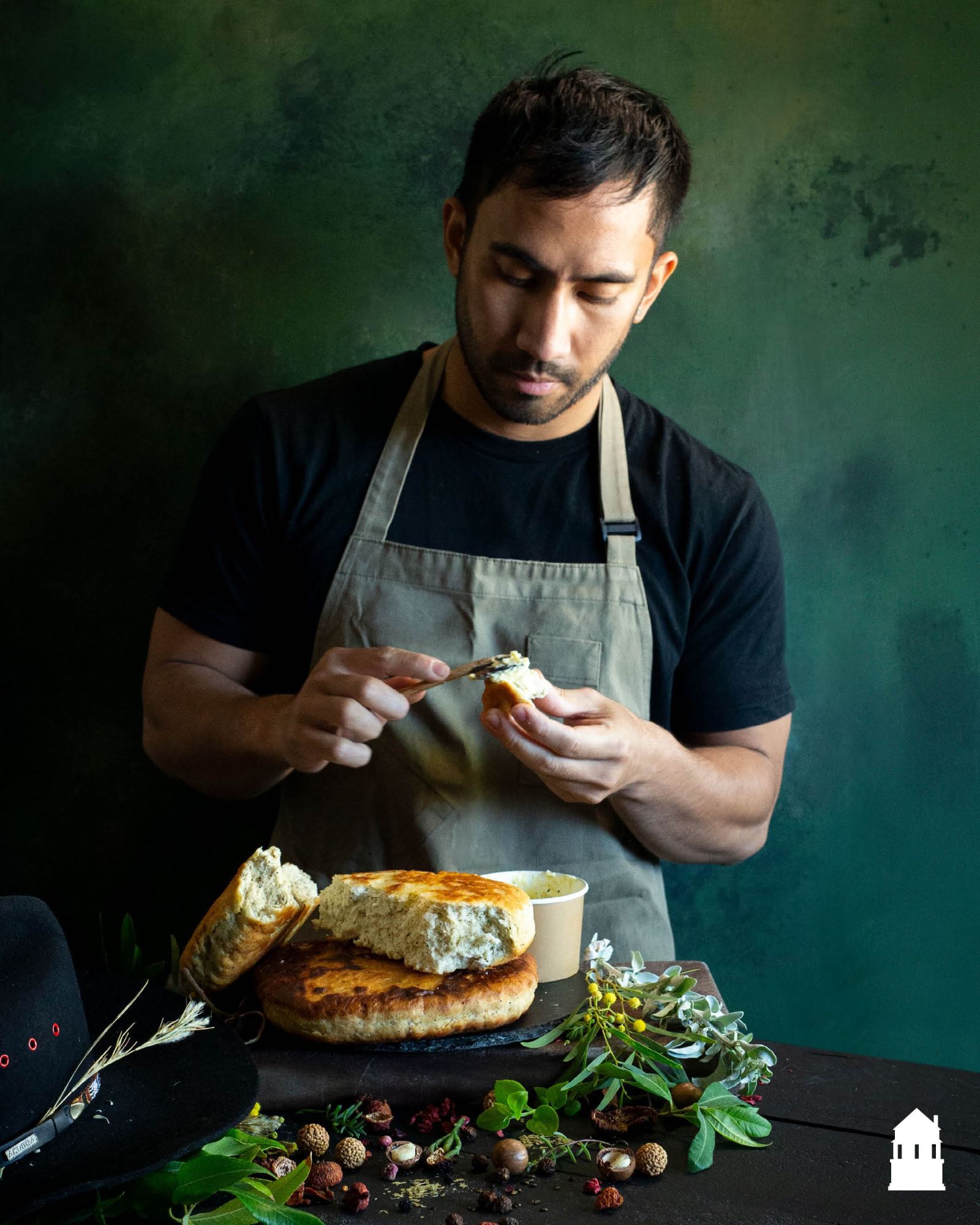 Chef Eddie Bulatao spreading native butter on fresh damper